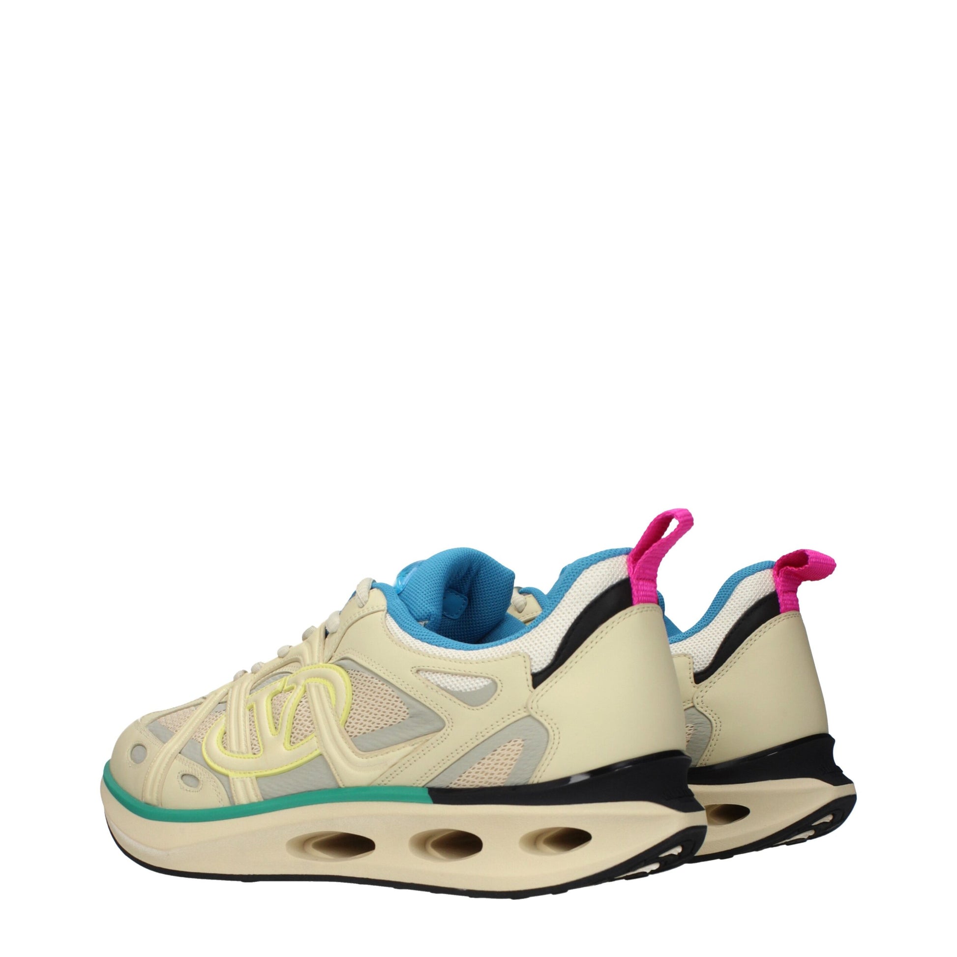 A pair of beige athletic sneakers with a pink lace and a green sole