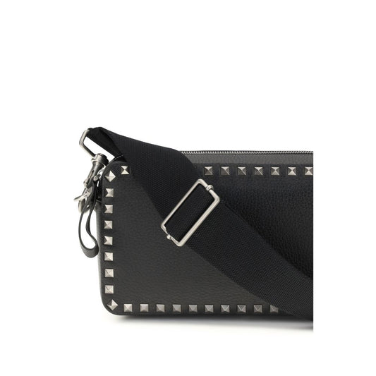 Black leather crossbody bag with silver studs on straps