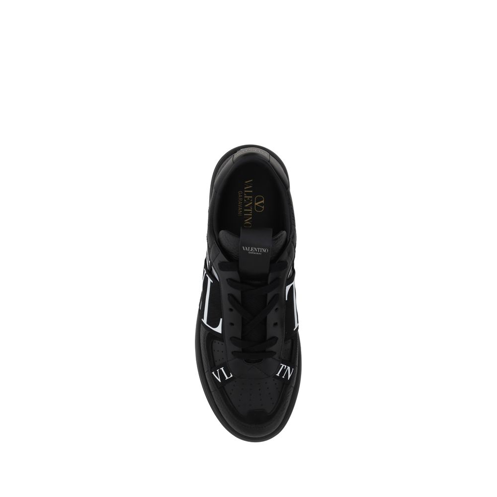 Black sneaker with white laces and logo on side