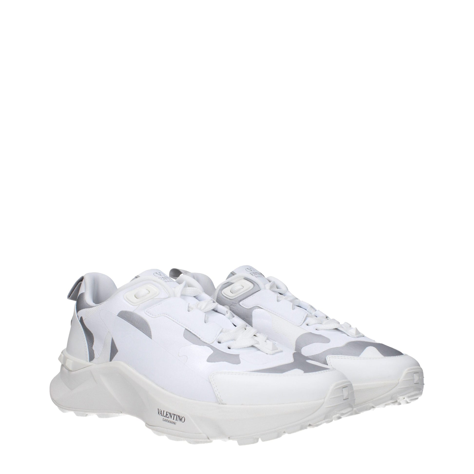 White athletic sneakers with camouflage pattern on side, featuring lace-up closure and logo on tongue
