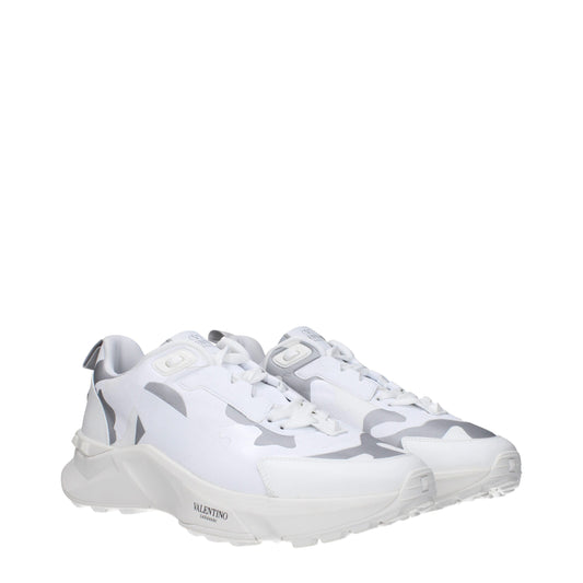 White athletic sneakers with camouflage pattern on side, featuring lace-up closure and logo on tongue