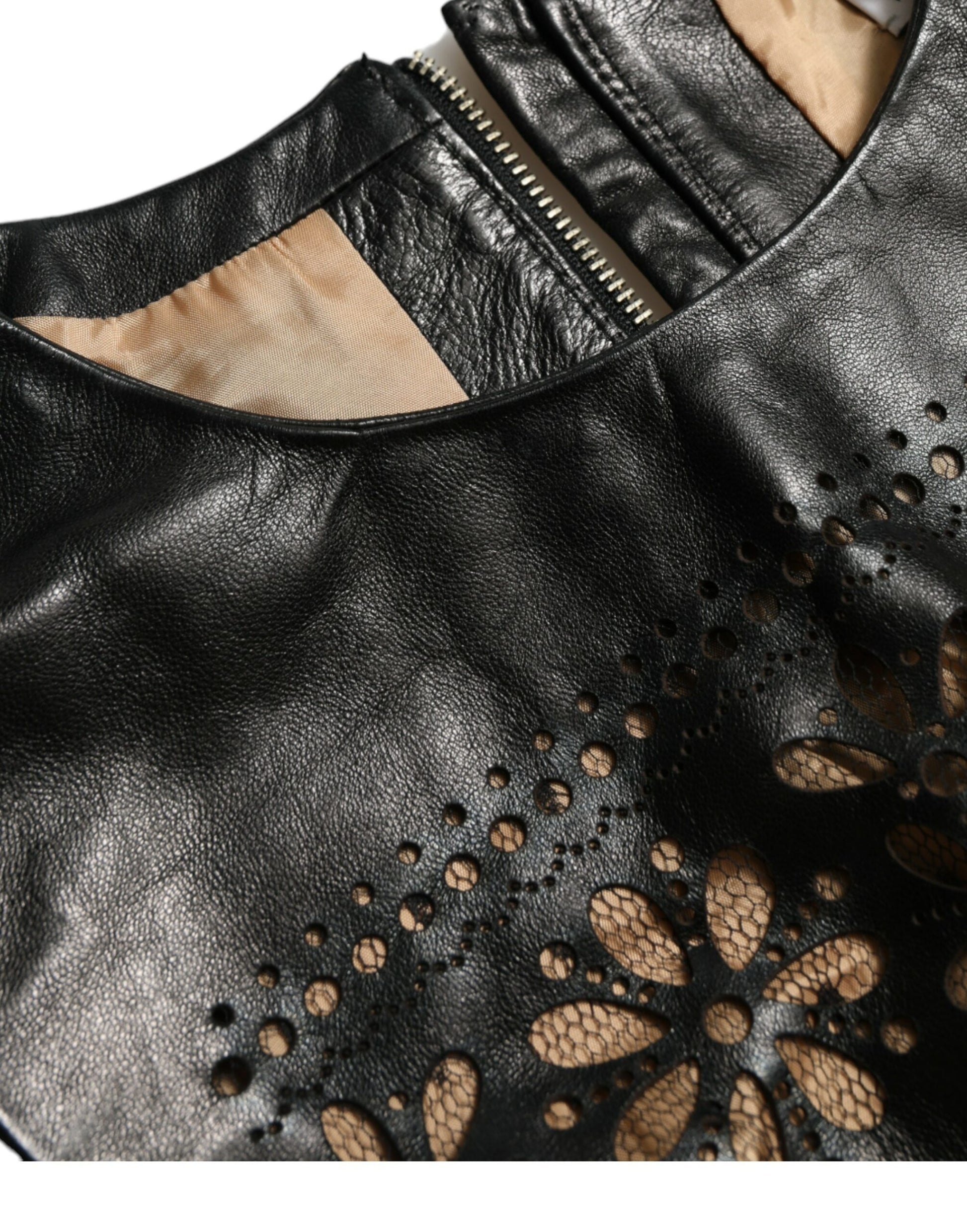 A black nylon dress with cut out details and a zipper closure