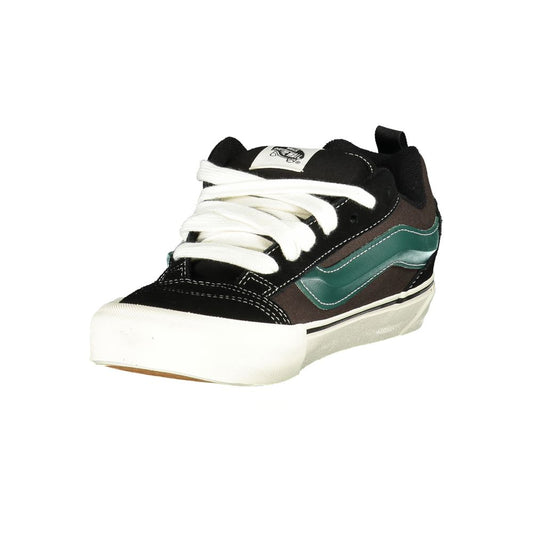A black and white sneaker with a green stripe on the side