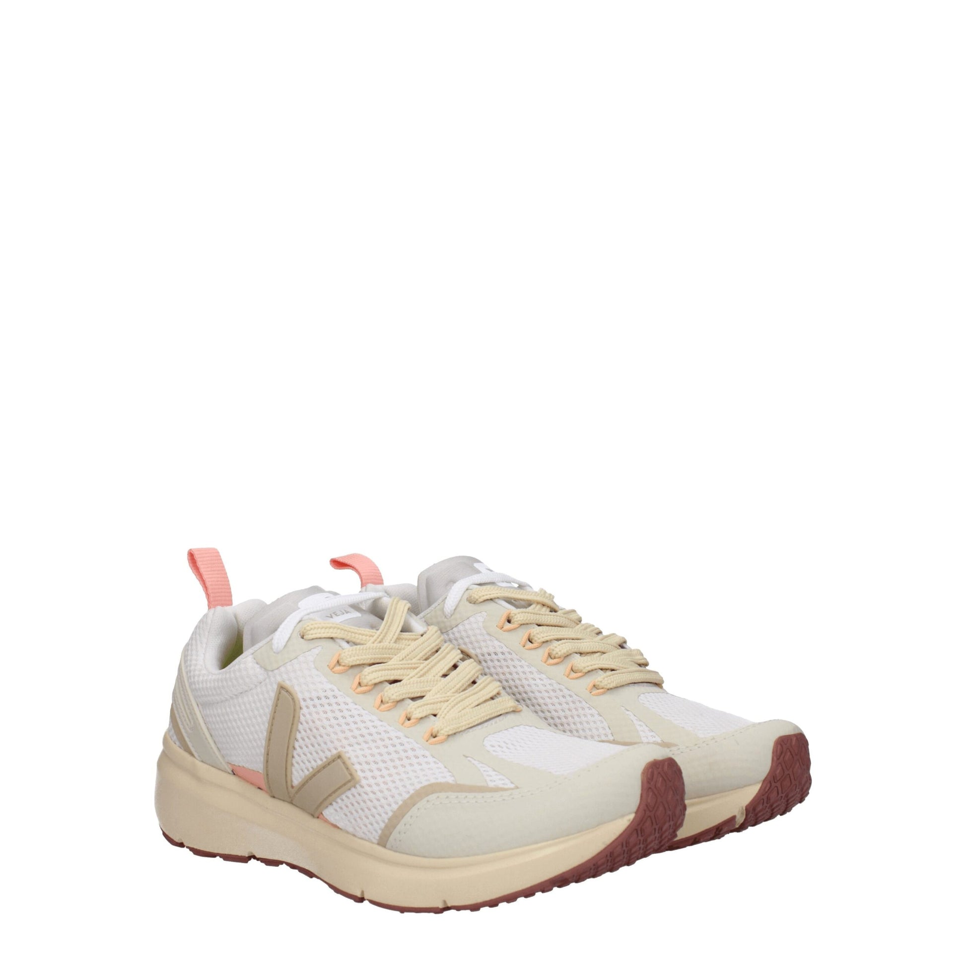 A pair of beige athletic sneakers with pink accents, featuring a lace-up closure and a pull tab on the back