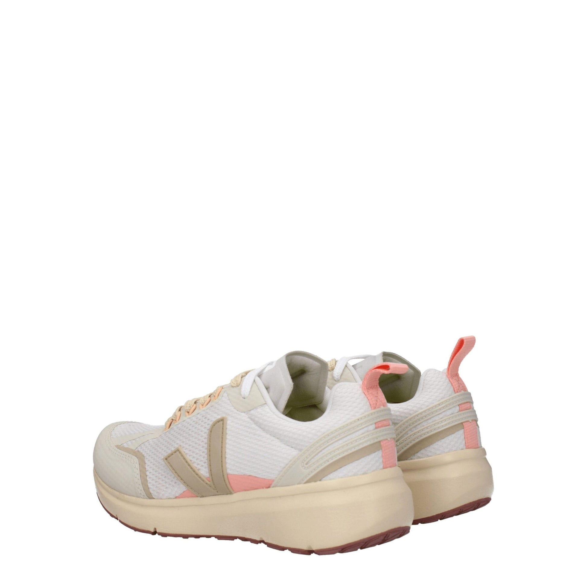 Pair of beige athletic sneakers with pink accents, featuring a lace-up front and chunky soles