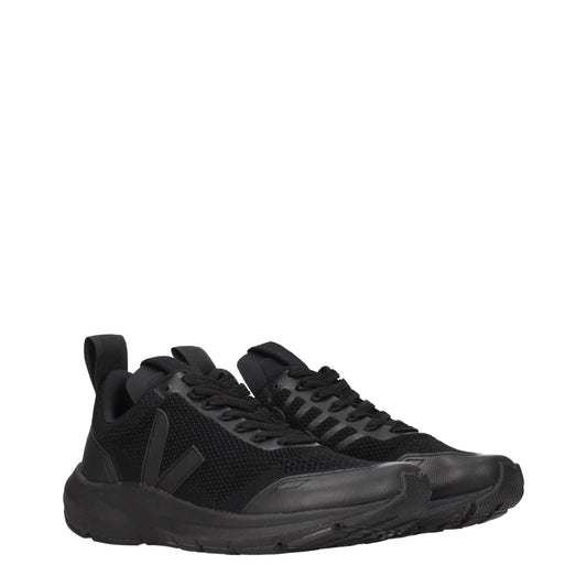 A pair of black athletic sneakers with a textured fabric upper, lace-up closure, and rubber sole