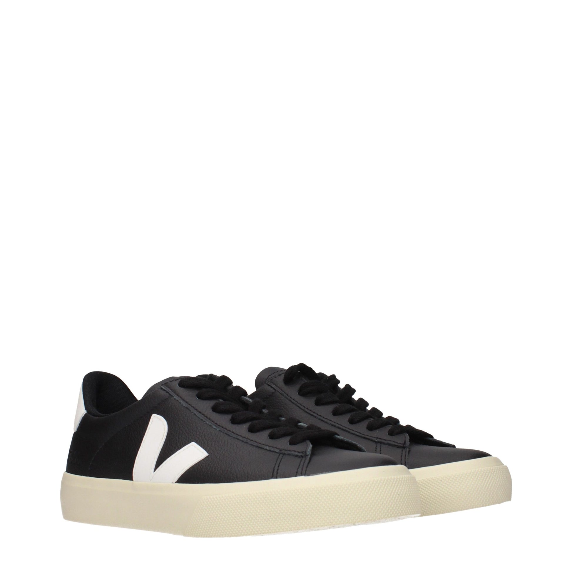 A pair of black leather low top sneakers with white stripe detailing on the side