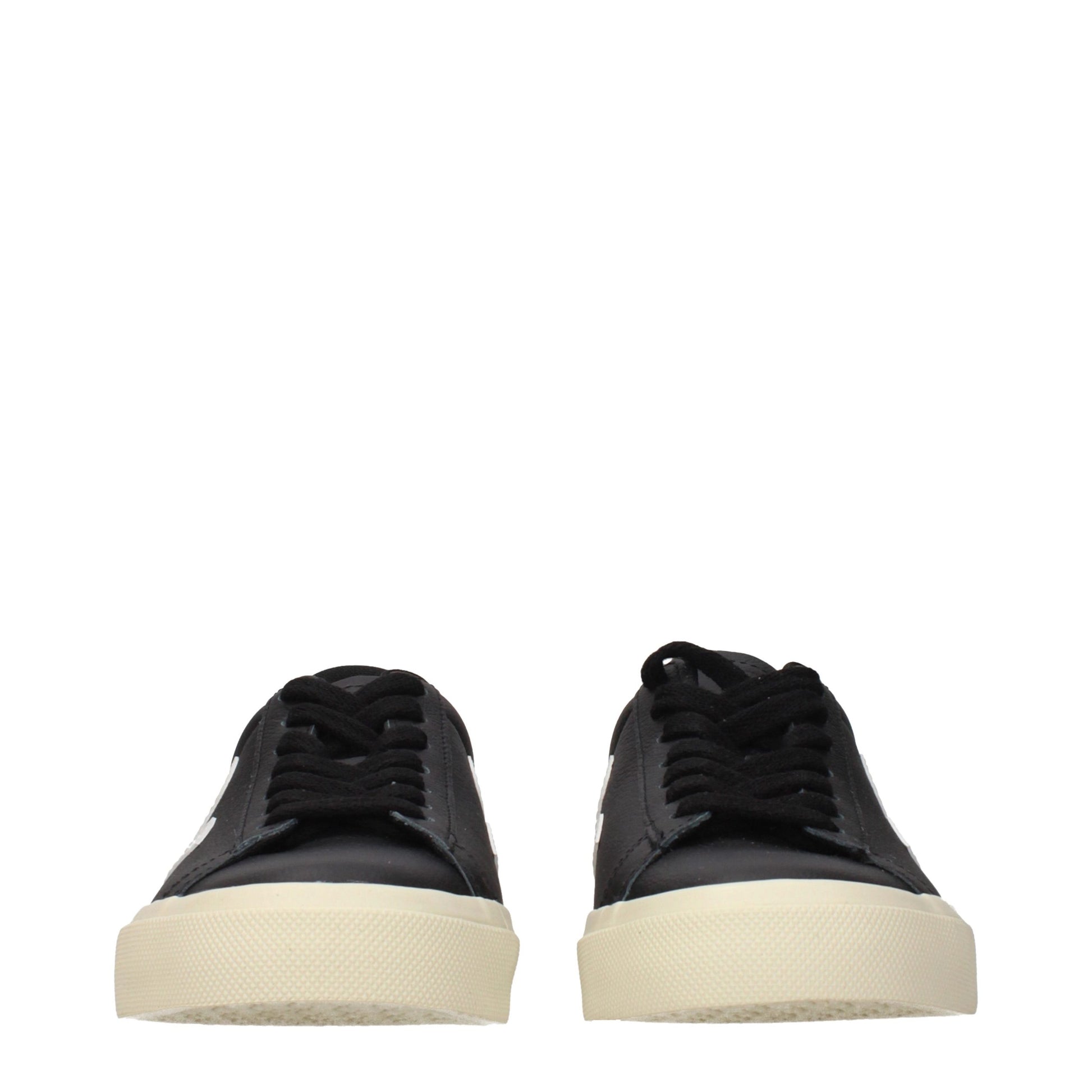 Pair of black leather low top sneakers with white soles