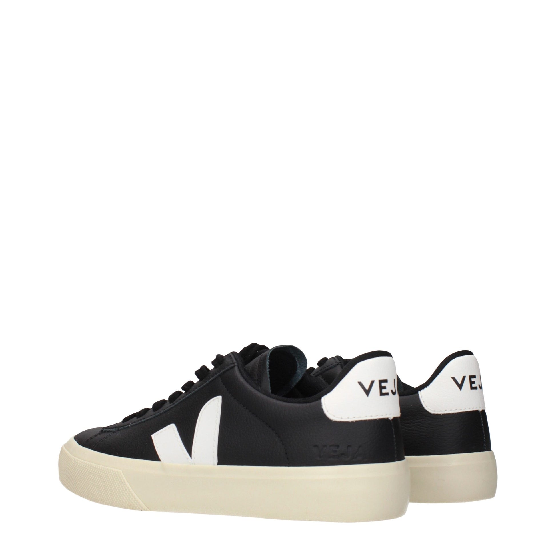 A pair of black leather low top sneakers with white laces and a white logo on the side