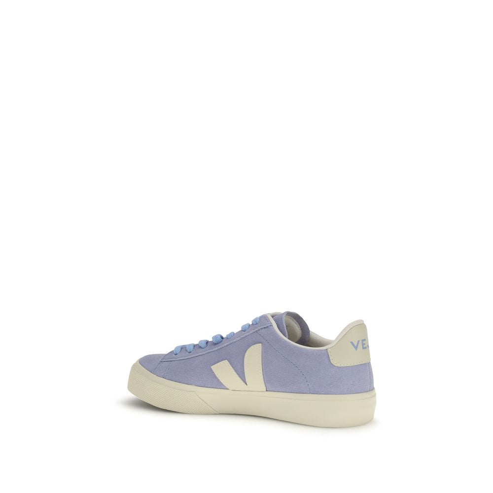 A pair of blue calf leather sneakers with white laces and a logo on the side
