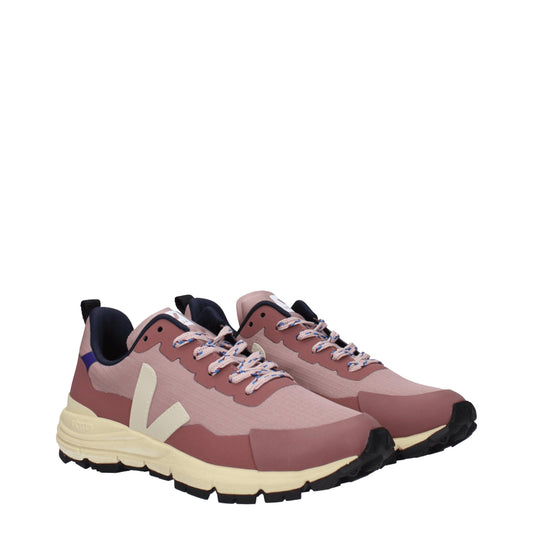 A pair of pink athletic sneakers with white laces, featuring a logo on the side and a fabric upper