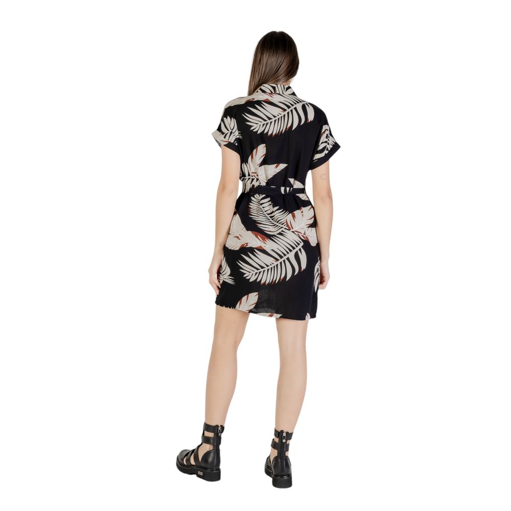A black and white short dress with a floral pattern on the front
