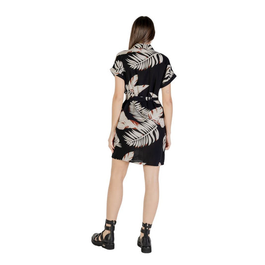 A black and white short dress with a floral pattern on the front