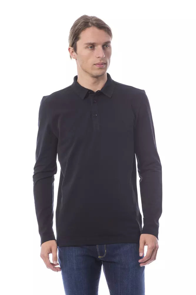 Man wearing black polo shirt and blue jeans