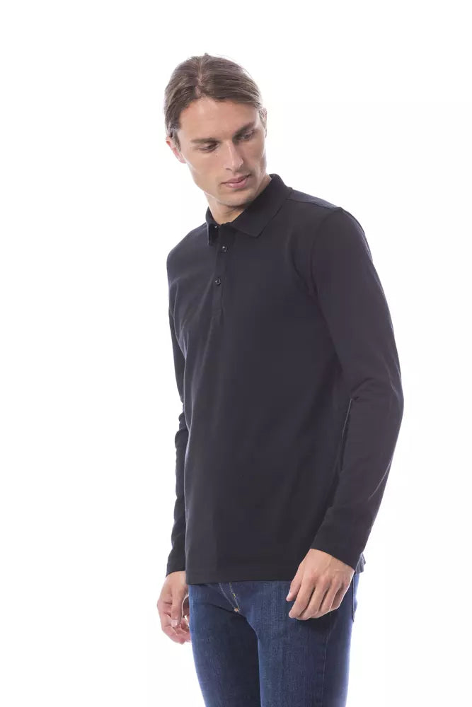 Man wearing black polo shirt and blue jeans