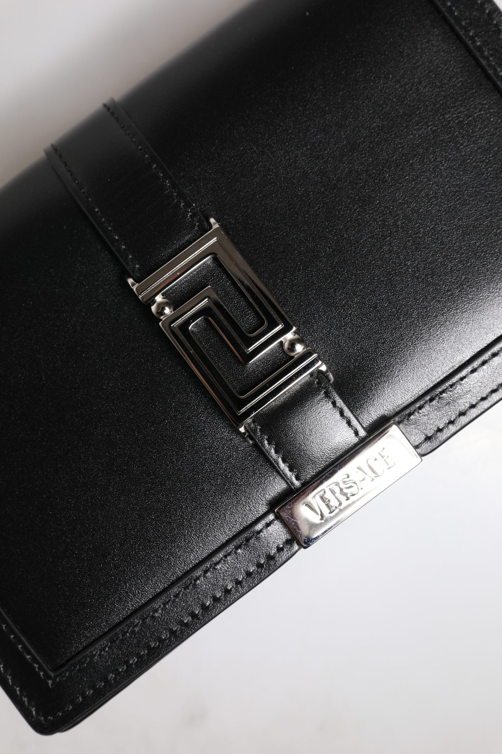 Black leather wallet with metal logo on front