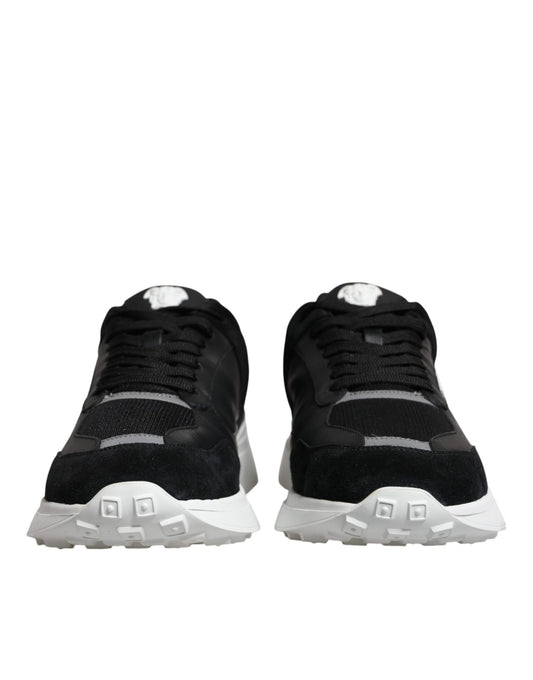 Pair of black canvas sneakers with white soles and laces, featuring a low top design