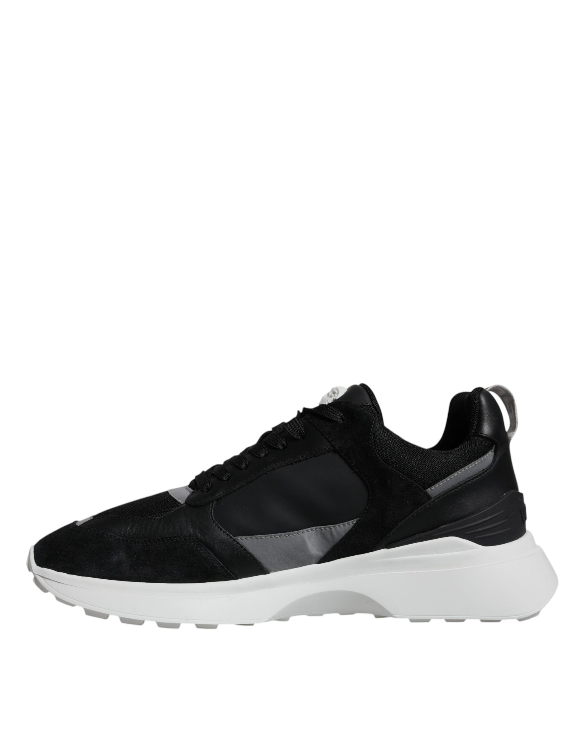 A pair of black canvas sneakers with white accents, featuring a low top design and the brand's logo