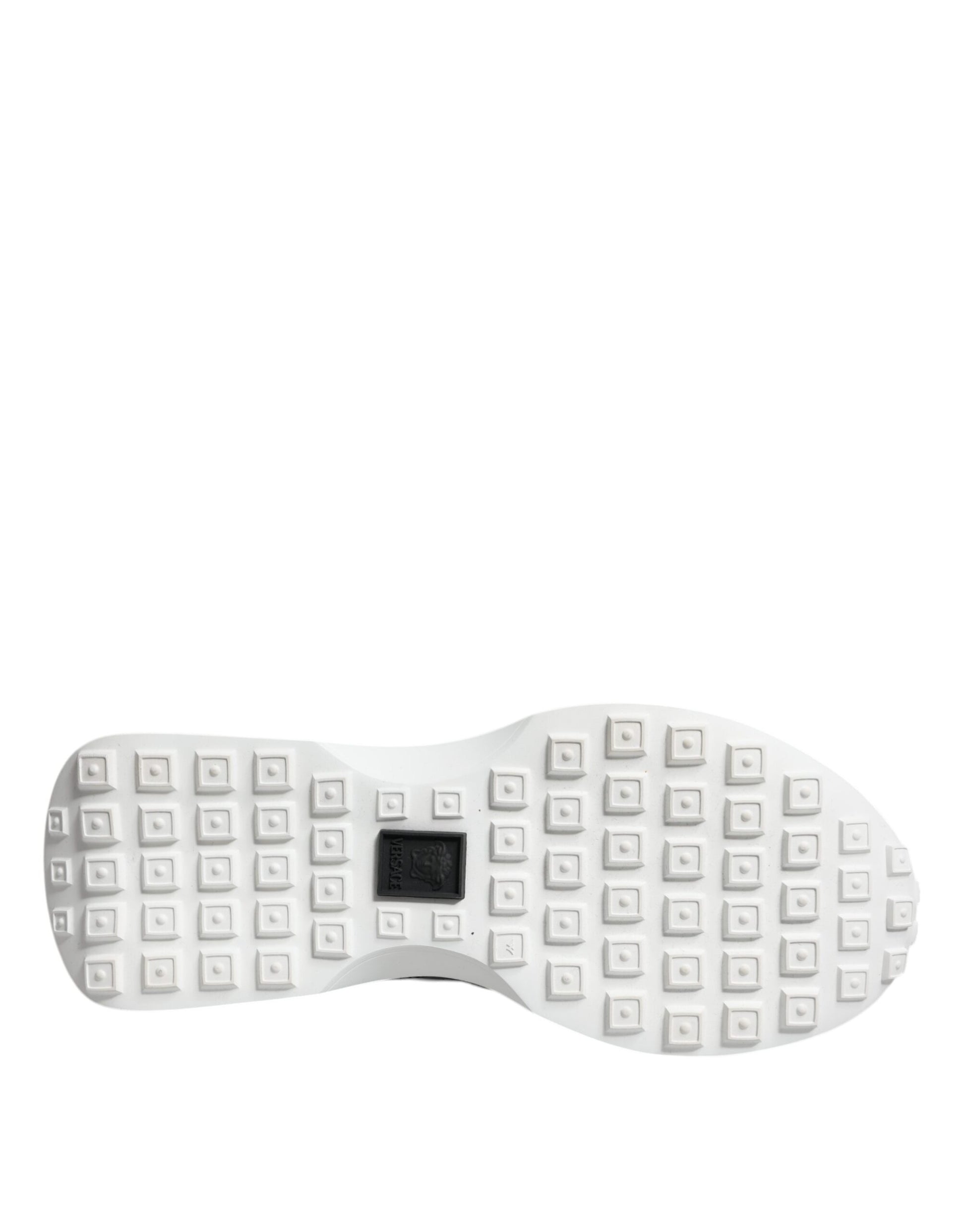White sneakers with black laces, featuring a textured sole and a low top design
