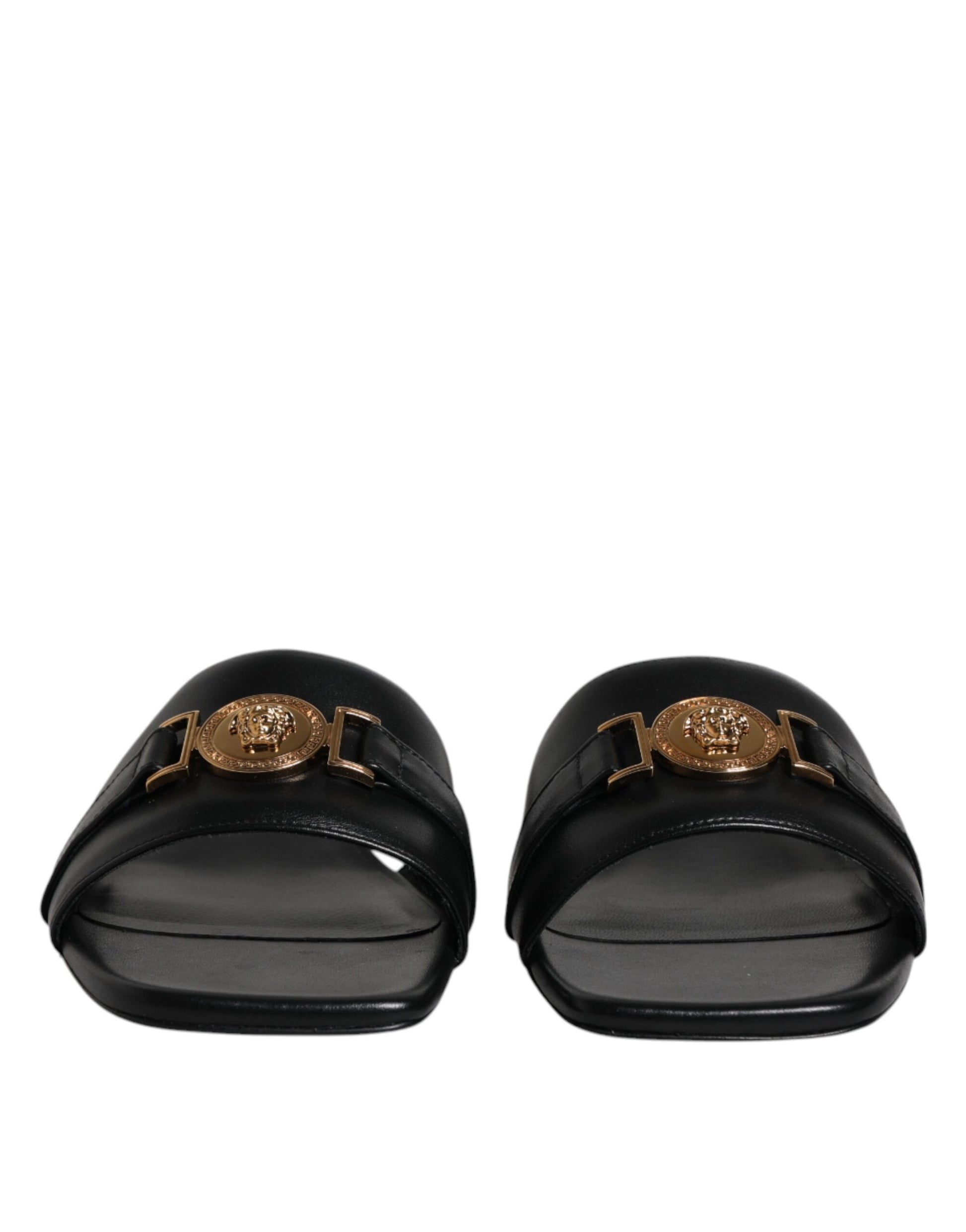 Pair of black loafers with gold buckle