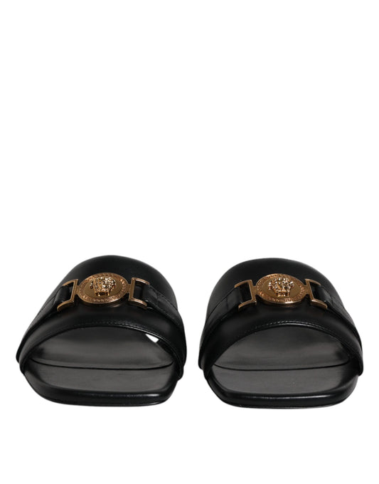 Pair of black loafers with gold buckle