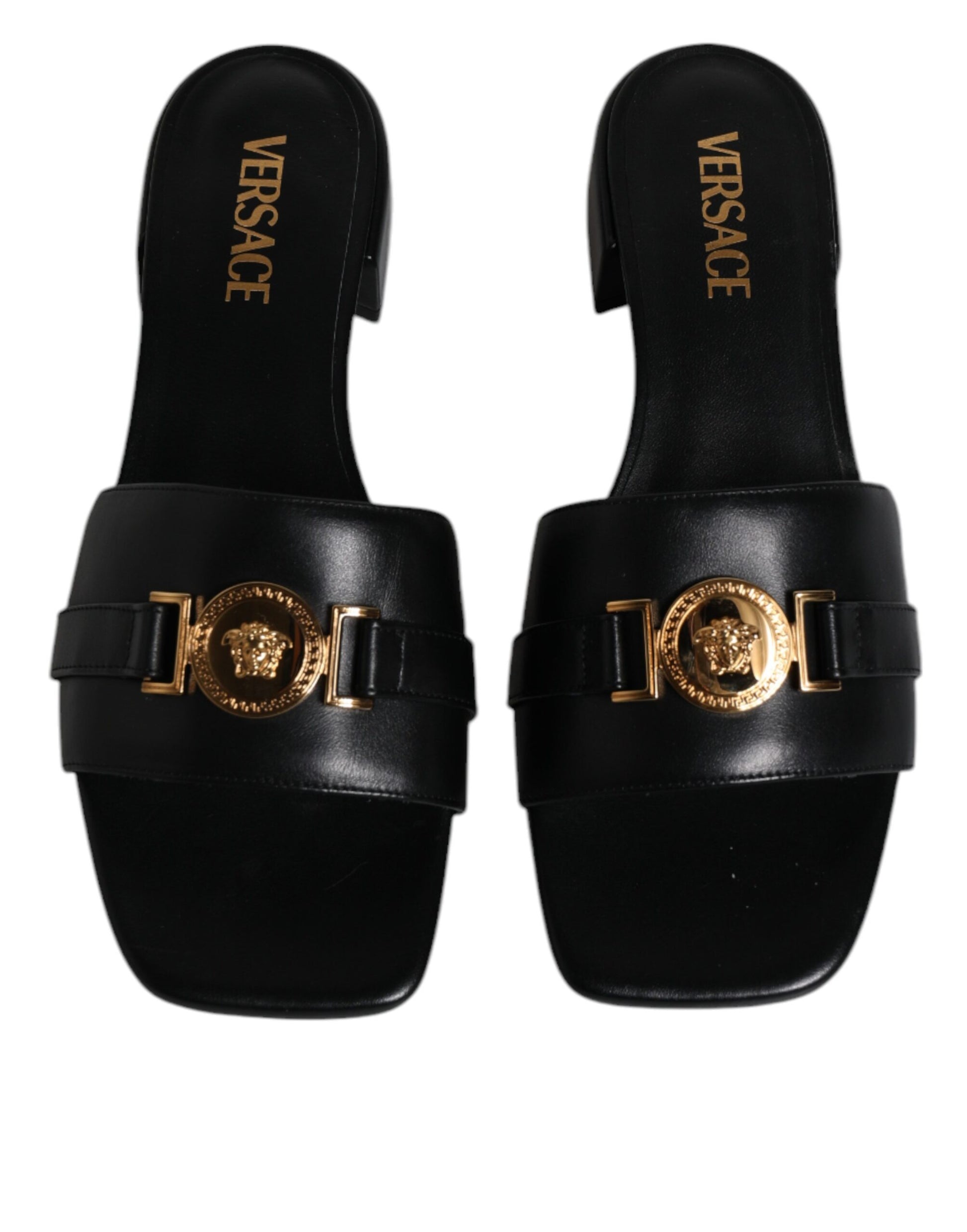 Pair of black sandals with gold buckles