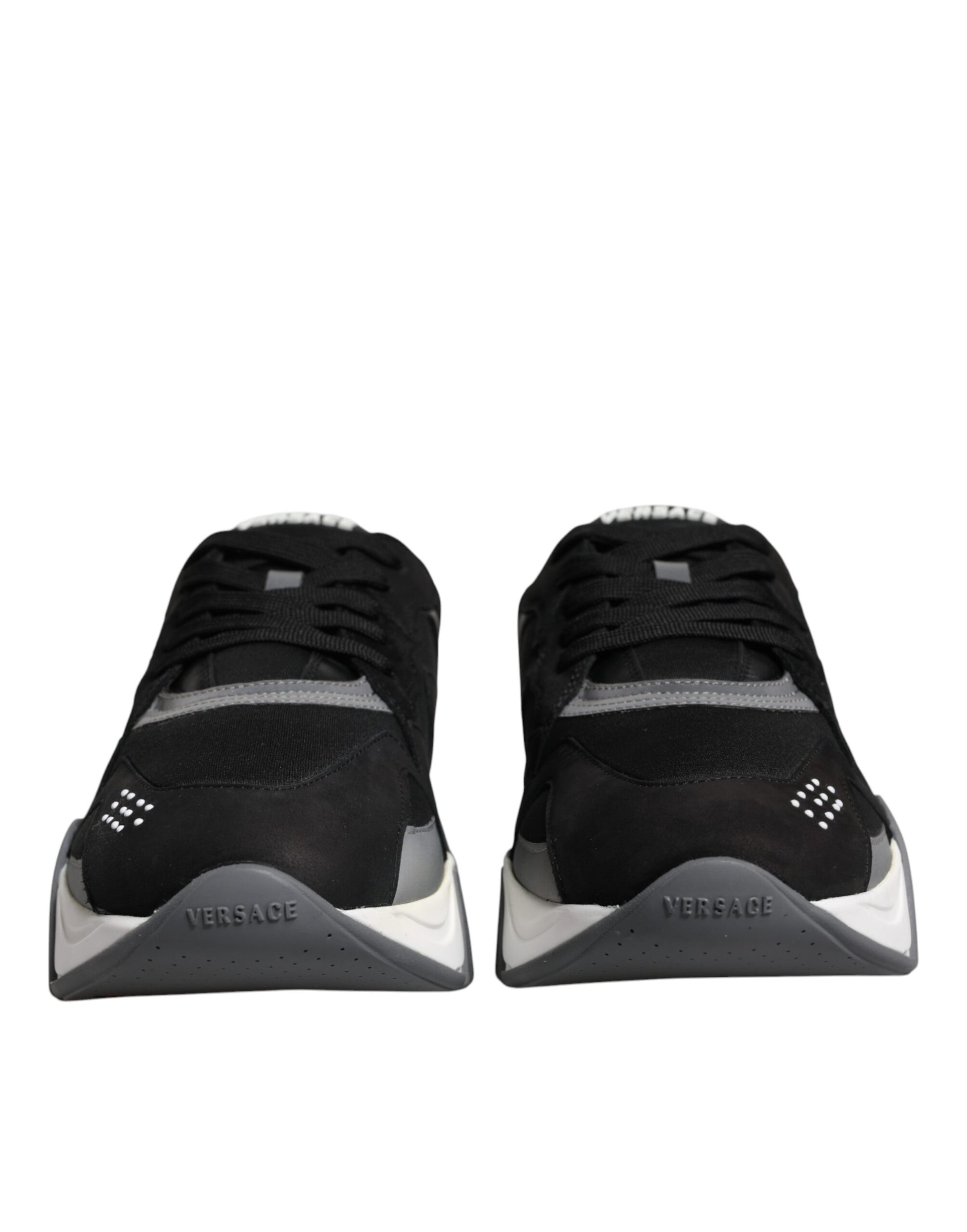 Pair of black and white sneakers with a logo on the side