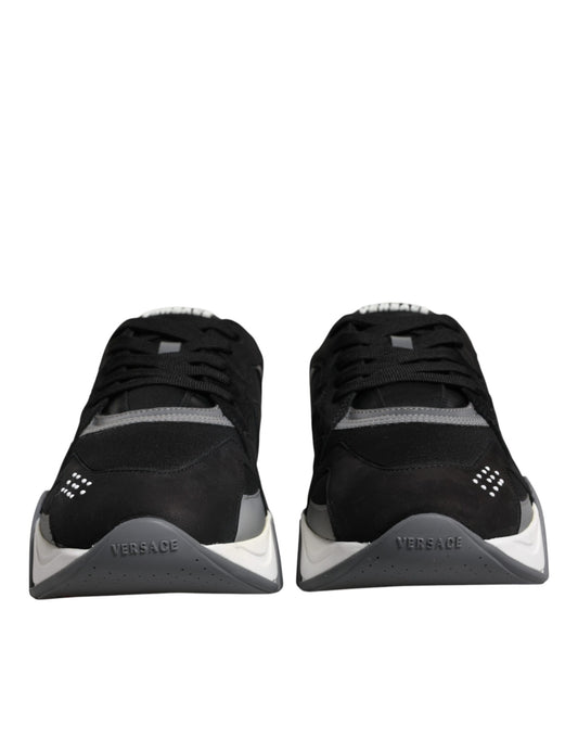 Pair of black and white sneakers with a logo on the side