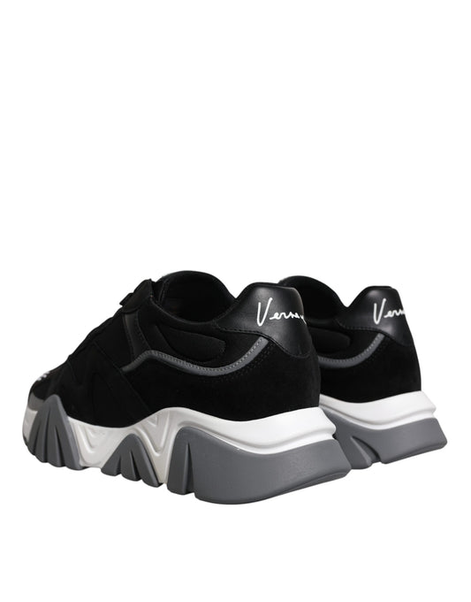 Pair of black and white sneakers with a logo on the side
