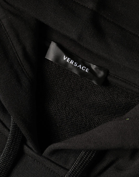 Black clothing item with white label reading "versace"