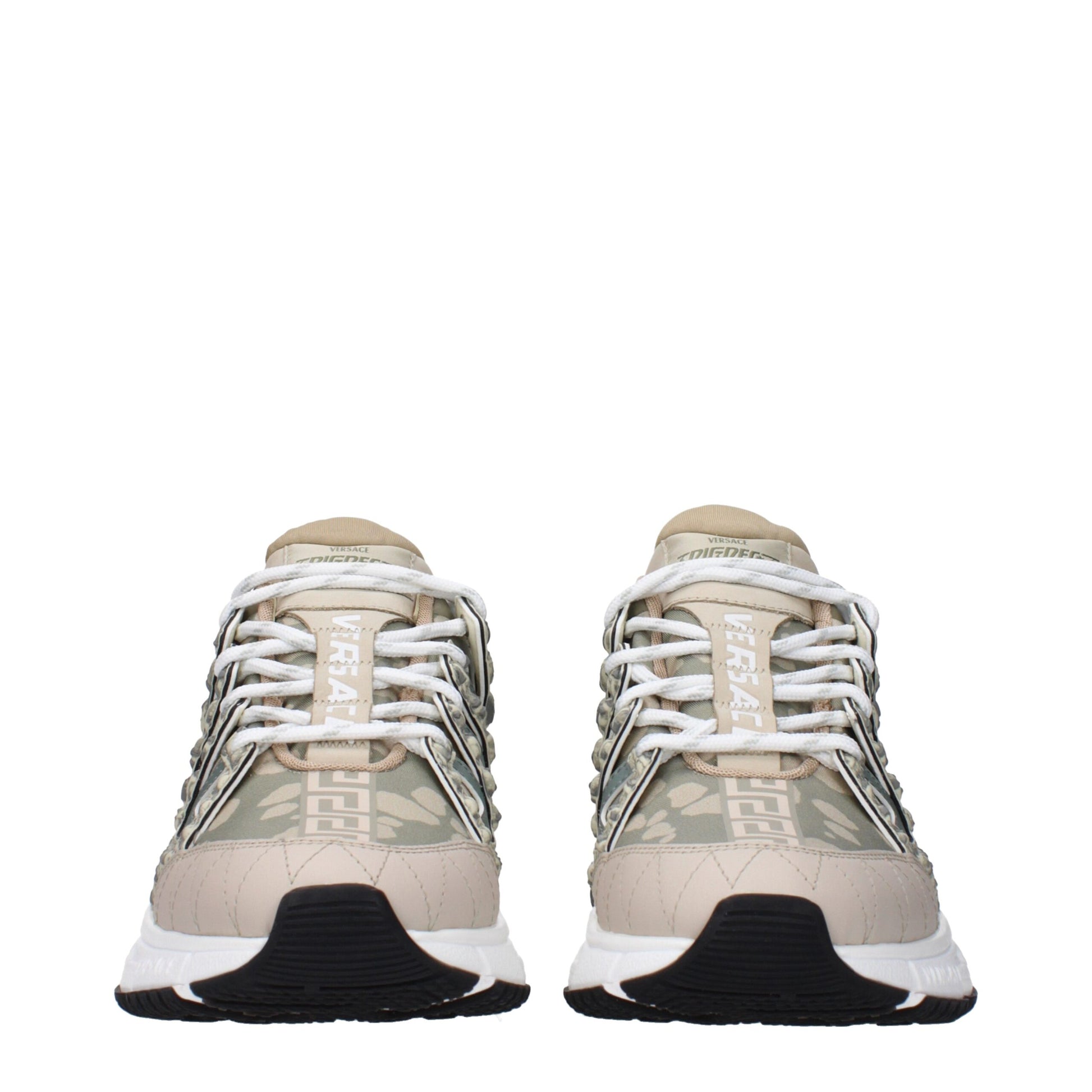 Pair of tan and green sneakers with white laces, featuring a low top design