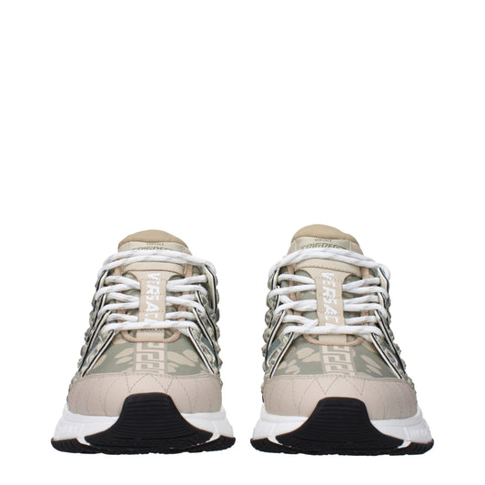 Pair of tan and green sneakers with white laces, featuring a low top design