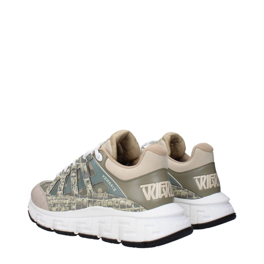 Pair of green fabric low top sneakers with white sole, featuring a camouflage pattern and the word "Versace" on side