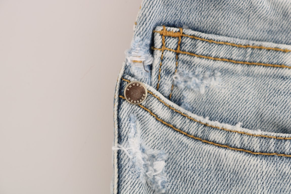 Blue denim jeans with frayed hem and button closure