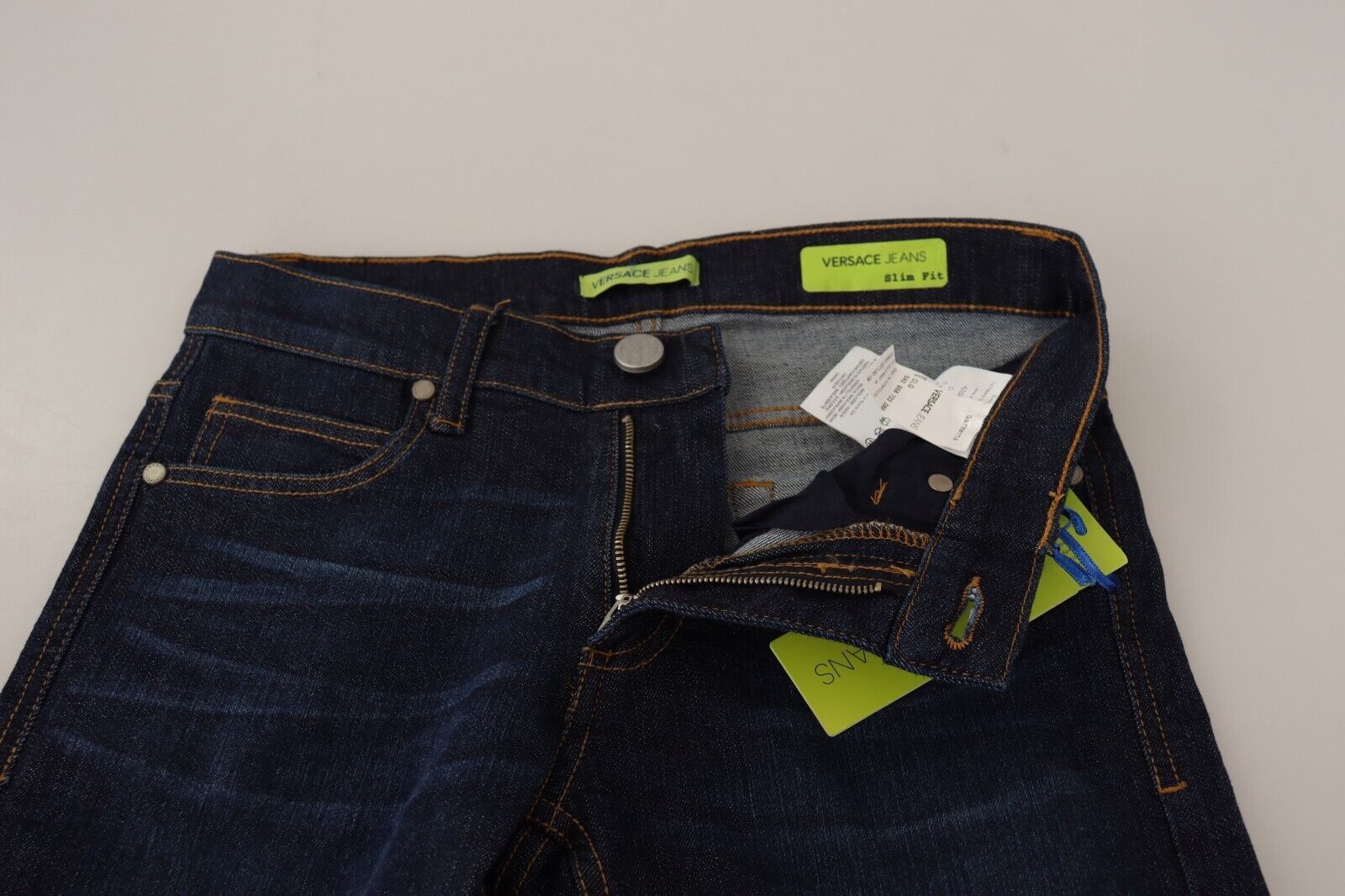 Pair of blue jeans with tags attached to waistband
