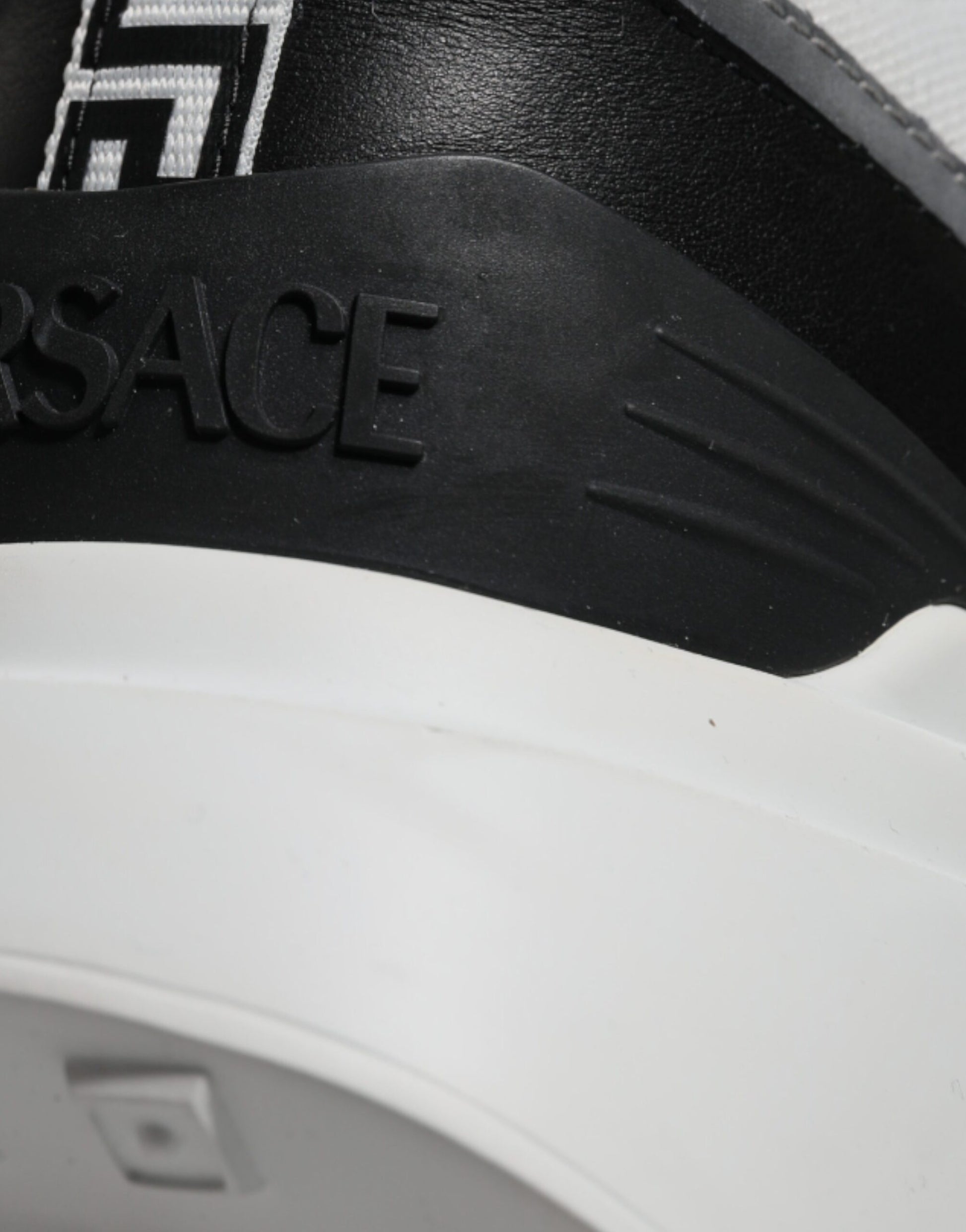Black and white sneaker with logo on side