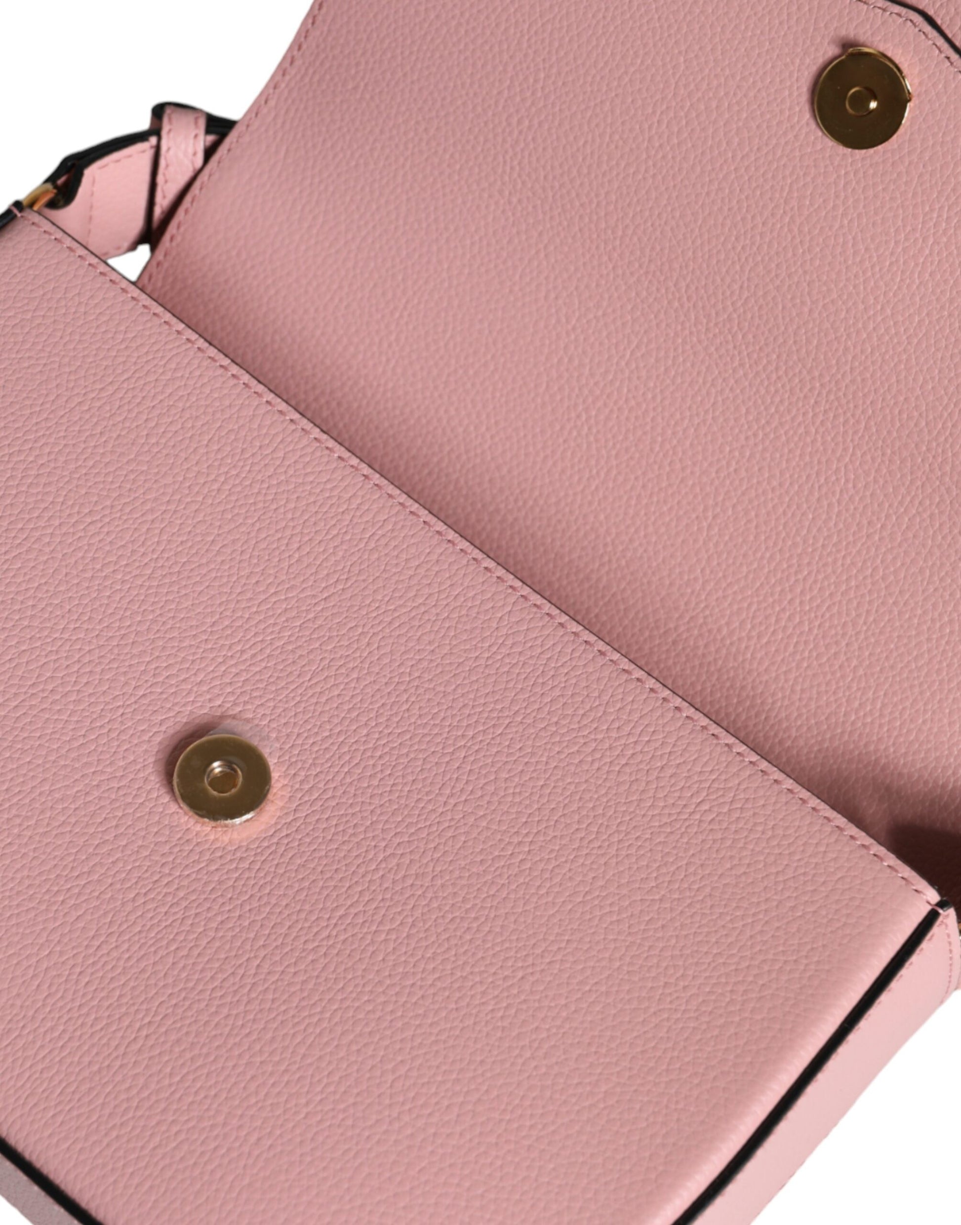 Pink leather wallet with gold button closure