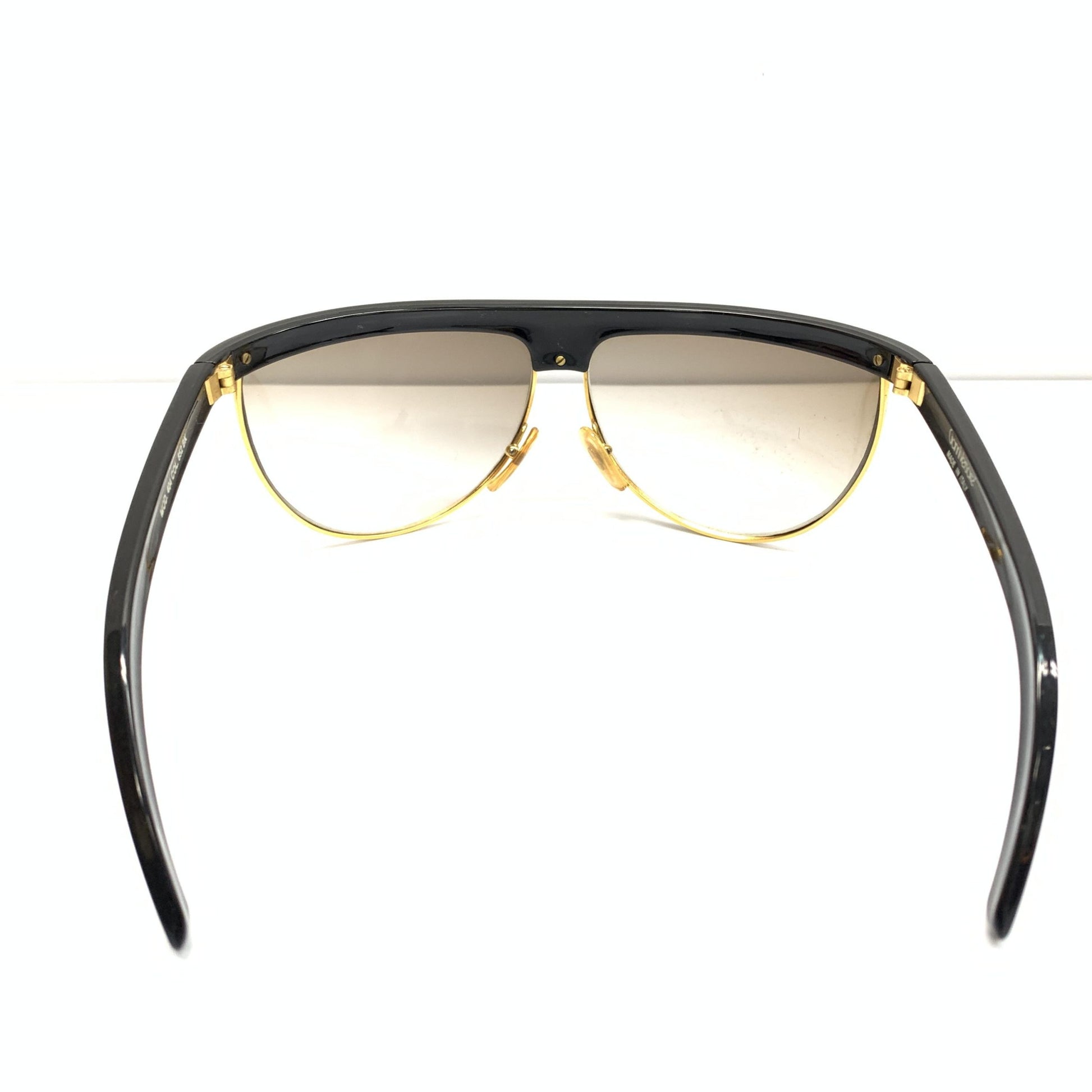 Pair of gold rimmed sunglasses