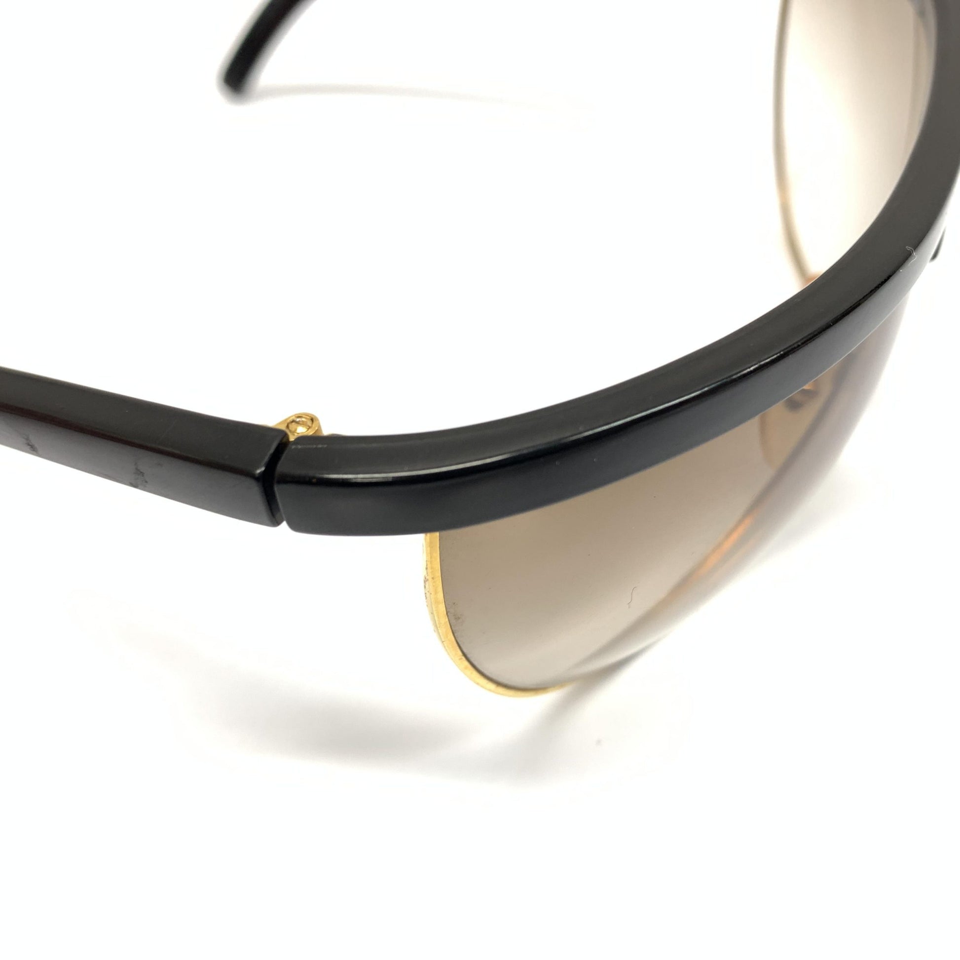 Sunglasses with gold accents on black frame