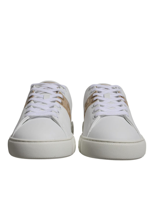 Pair of white sneakers with tan laces and a small logo on the side