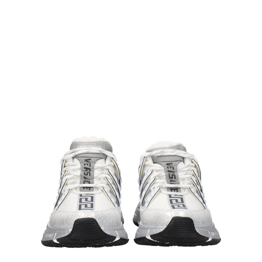 Pair of white athletic sneakers with black laces, branded logo on side and tongue, featuring a textured fabric upper