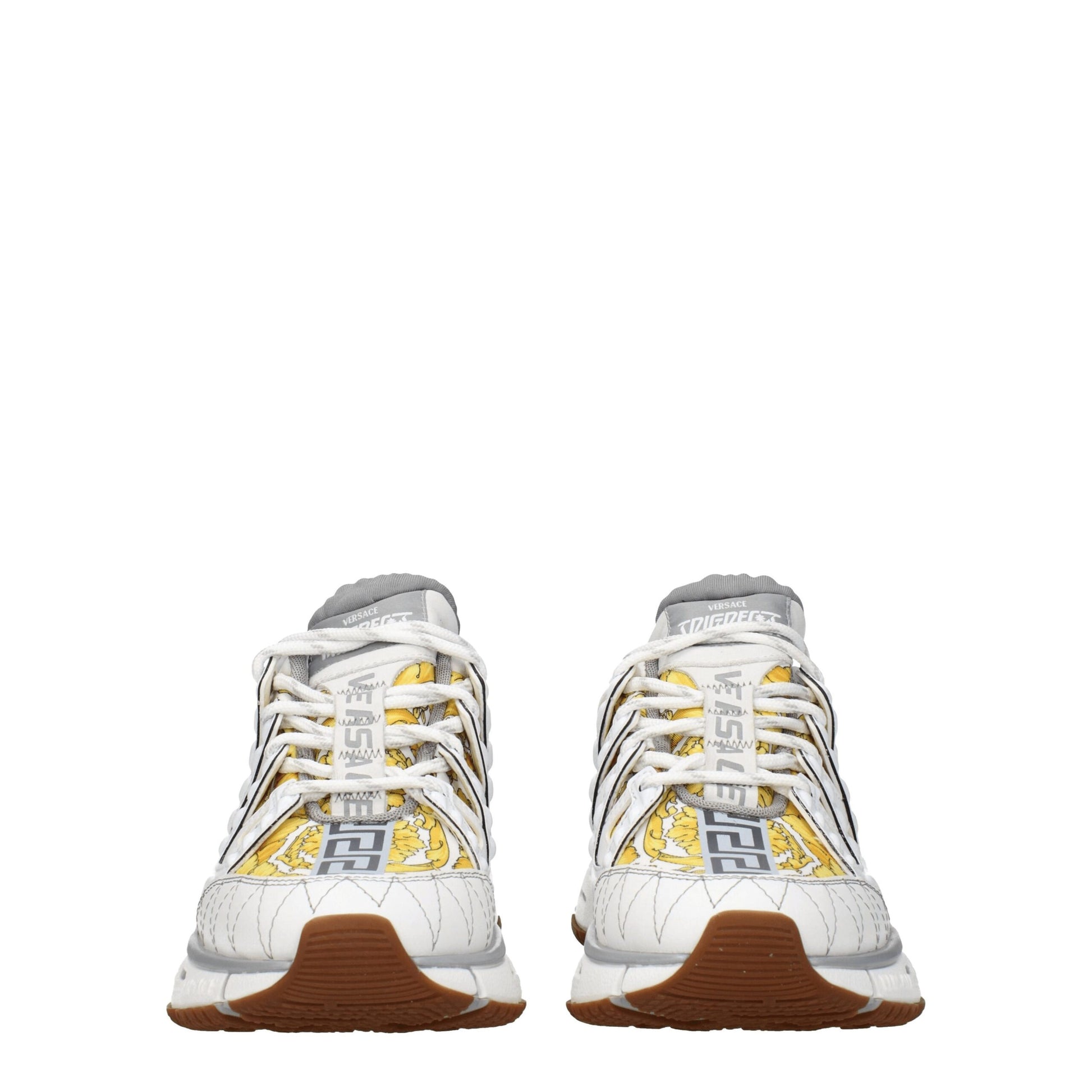 Pair of white athletic sneakers with yellow accents, featuring a logo on the side and laces