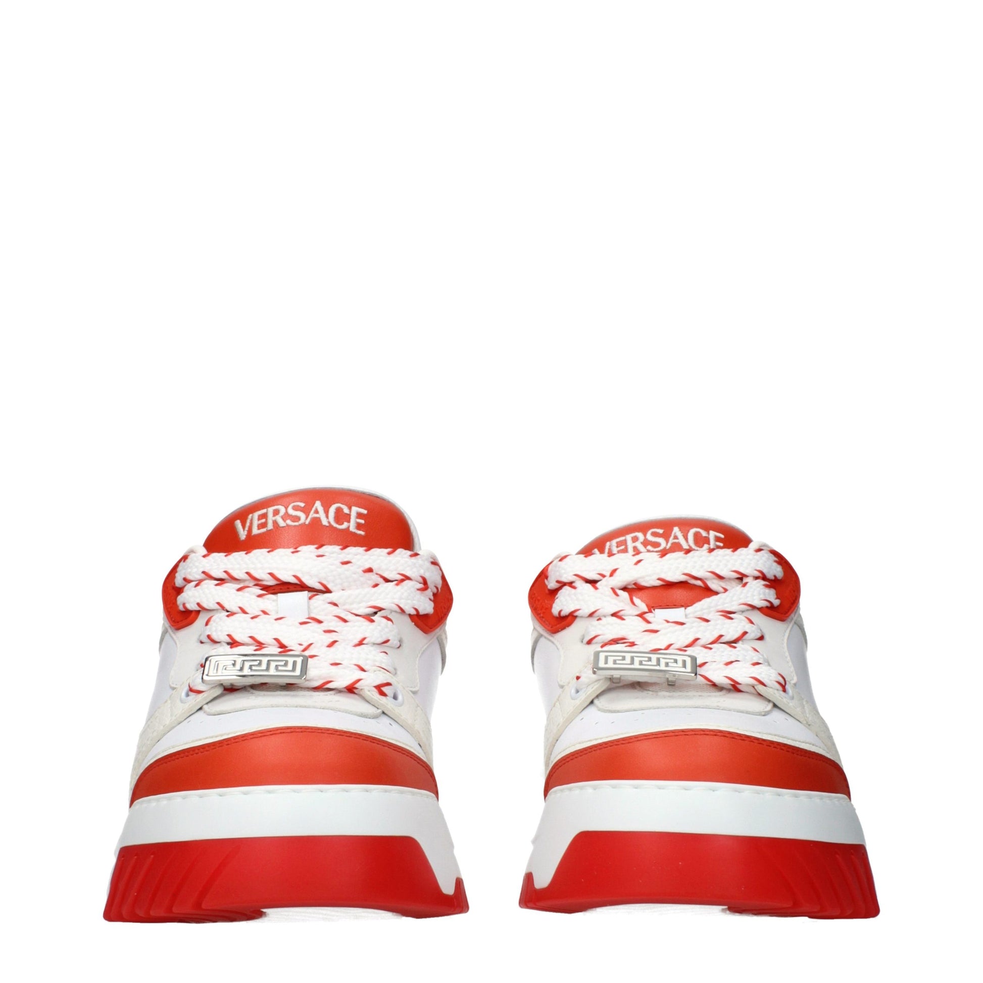 Red and white athletic sneakers with brand name on side, laces tied in bow