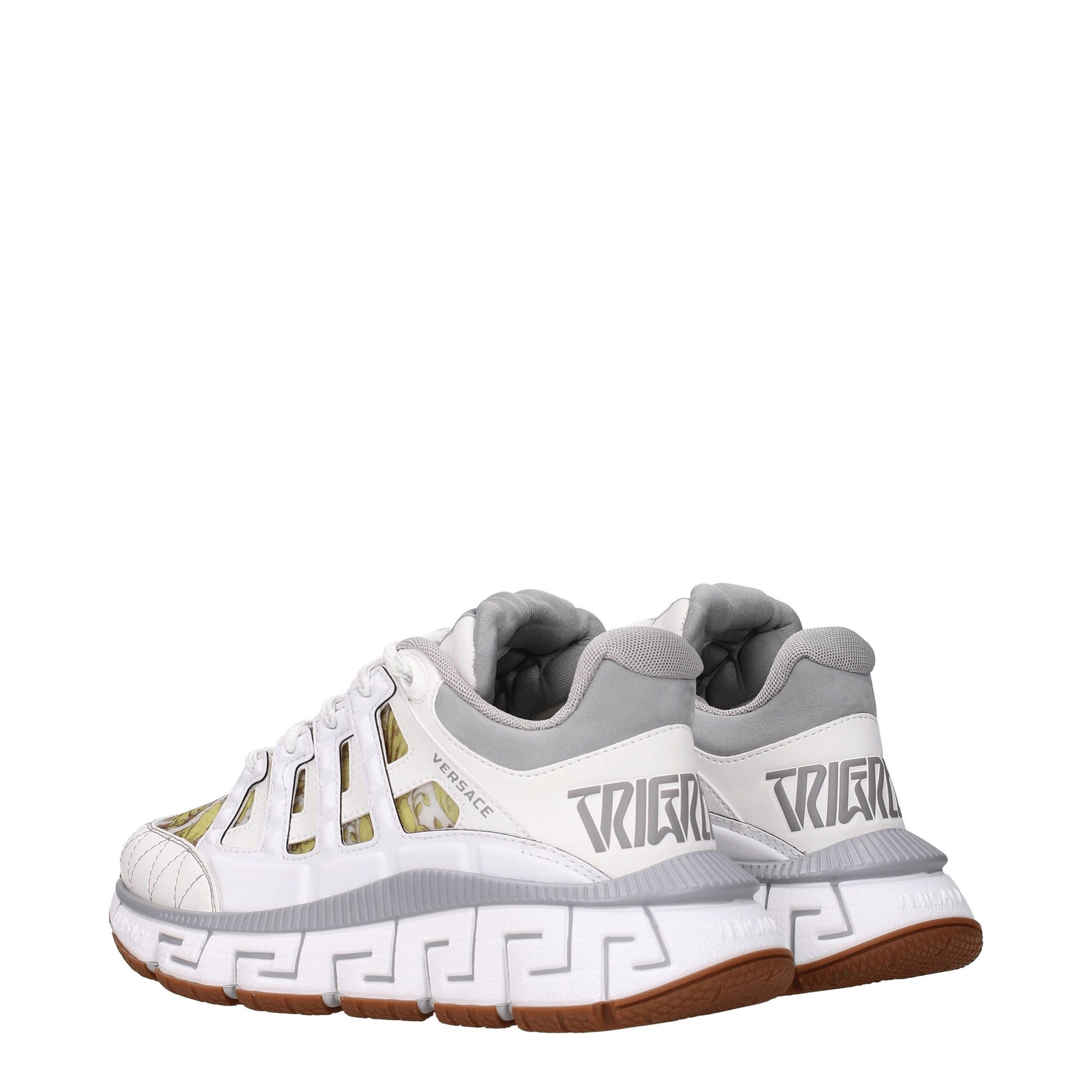 Versace white leather athletic sneakers with gold accents, featuring a unique design on the side and tongue