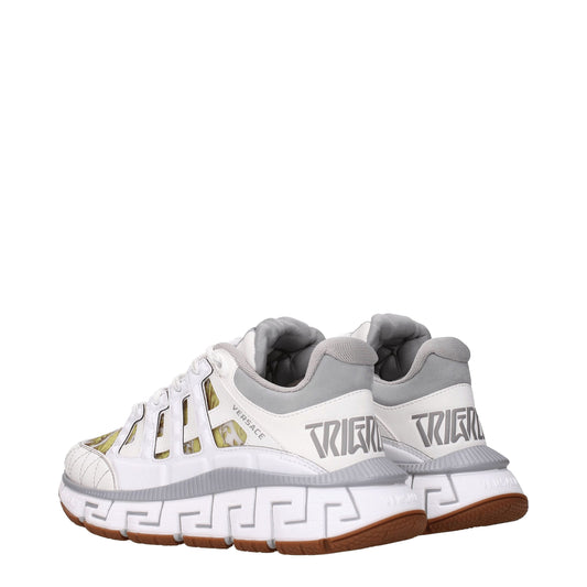 Versace white leather athletic sneakers with gold accents, featuring a unique design on the side and tongue