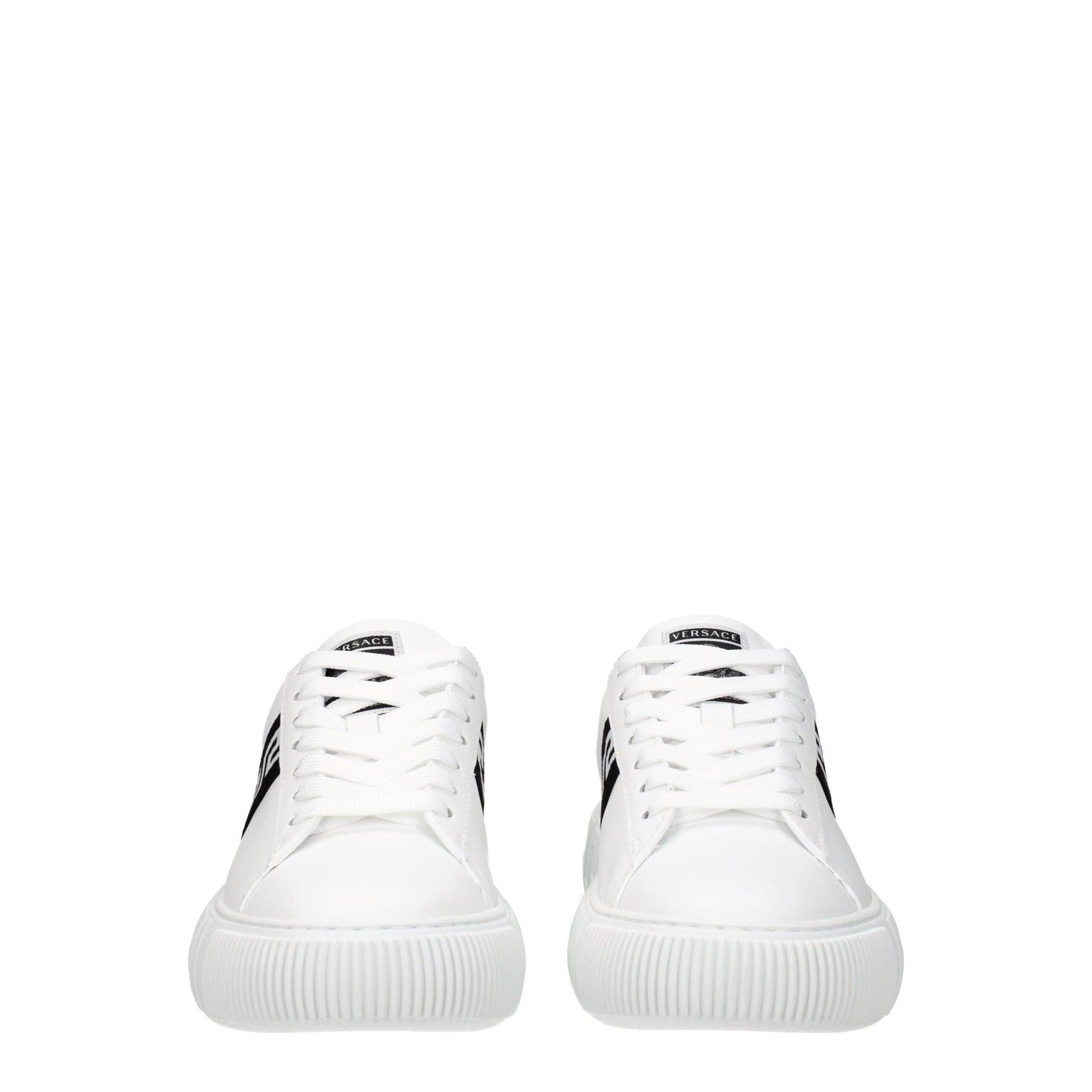 Pair of white leather low top sneakers with black laces and logo on side