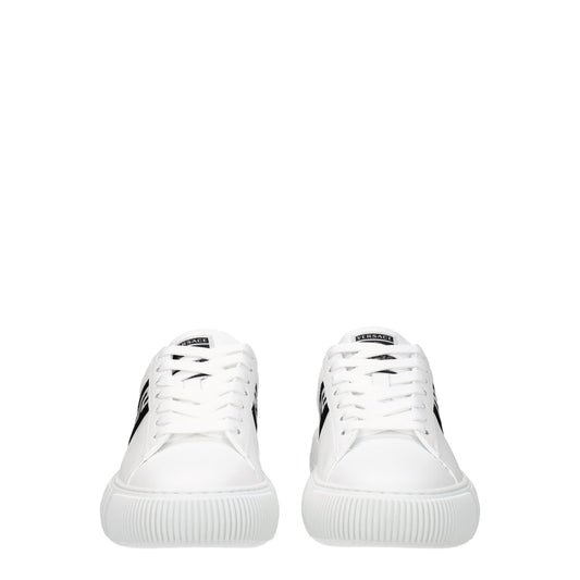 Pair of white leather low top sneakers with black laces and logo on side