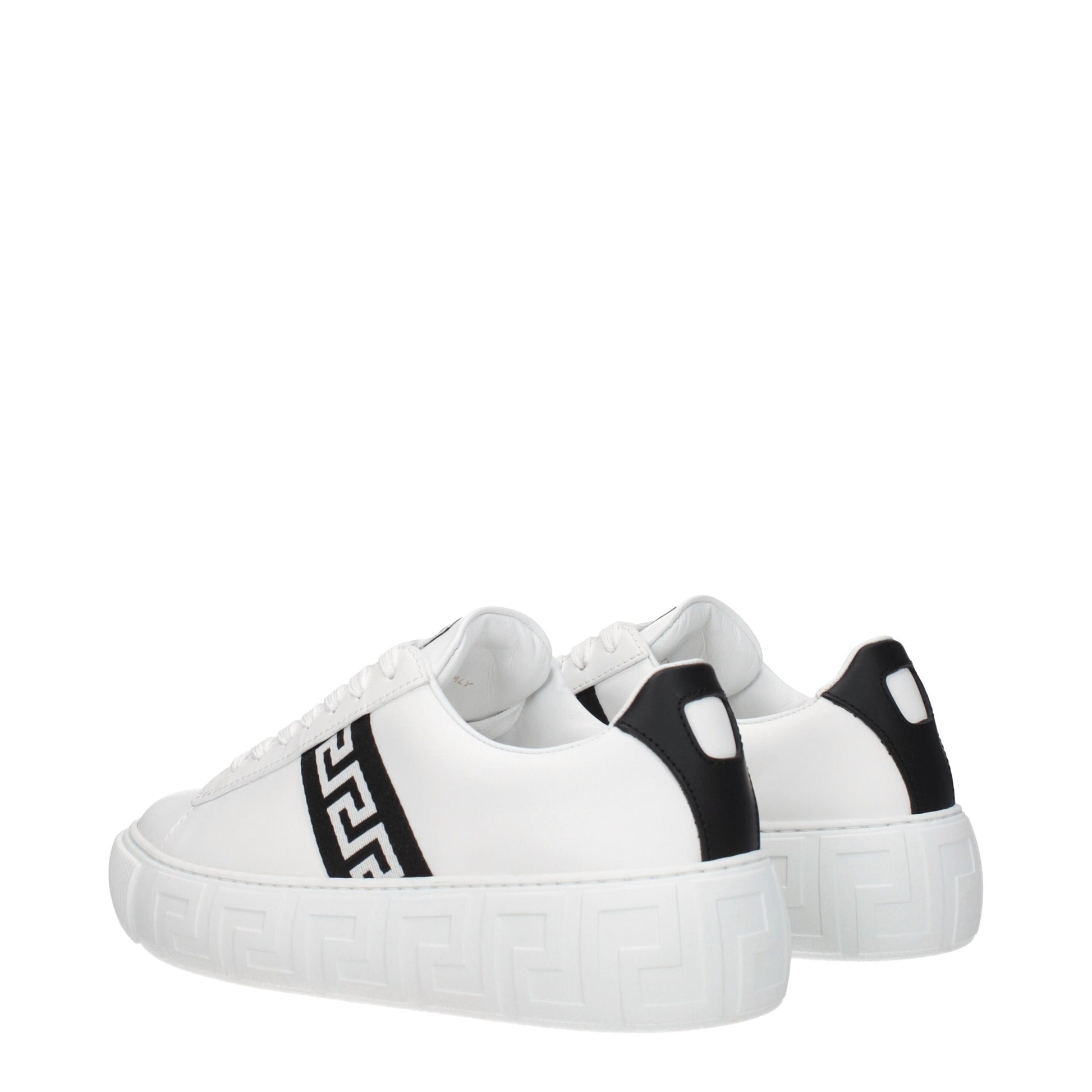 A pair of white leather sneakers with black laces, featuring a low top design and a distinctive pattern on the side