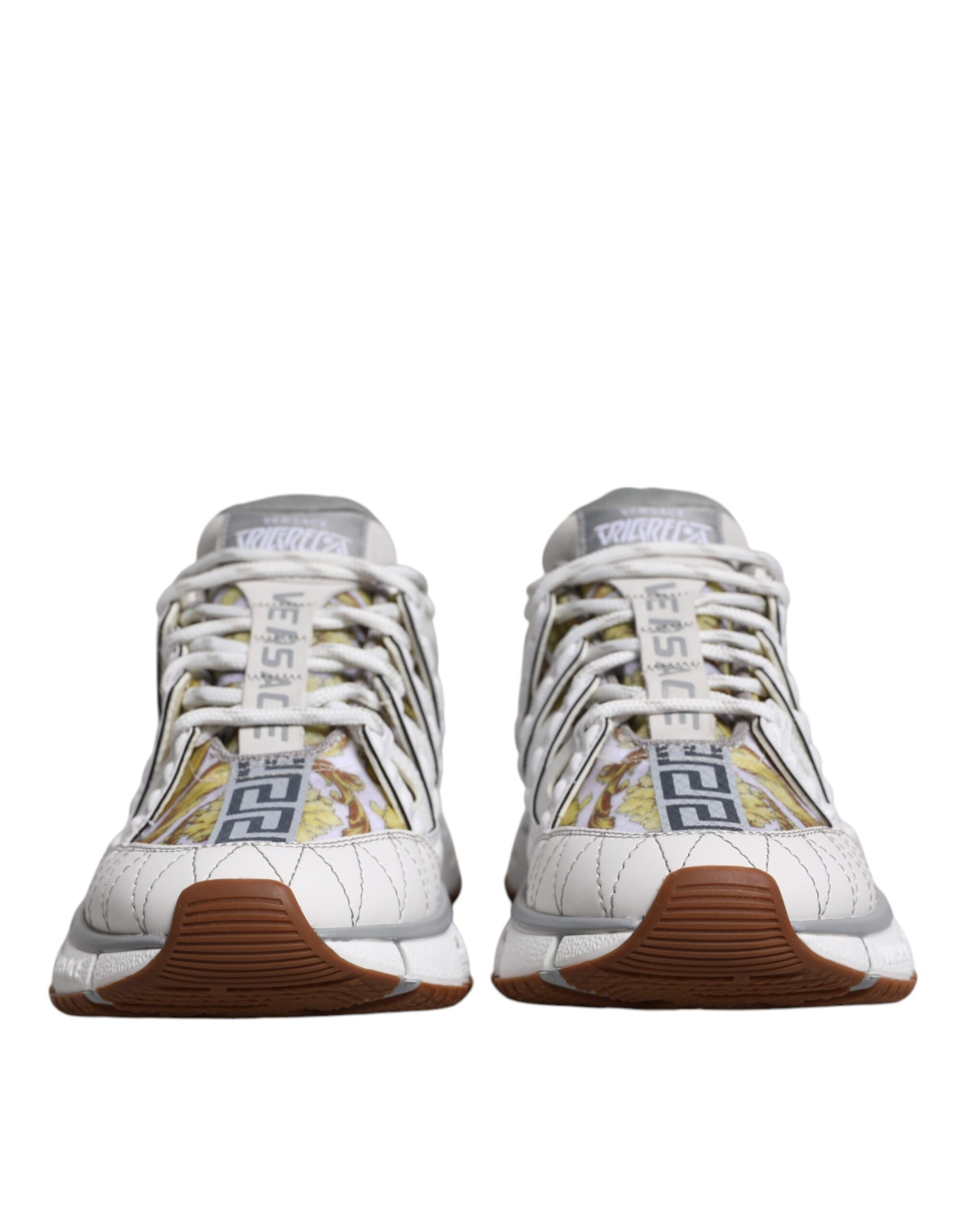 Pair of white and black sneakers with yellow accents