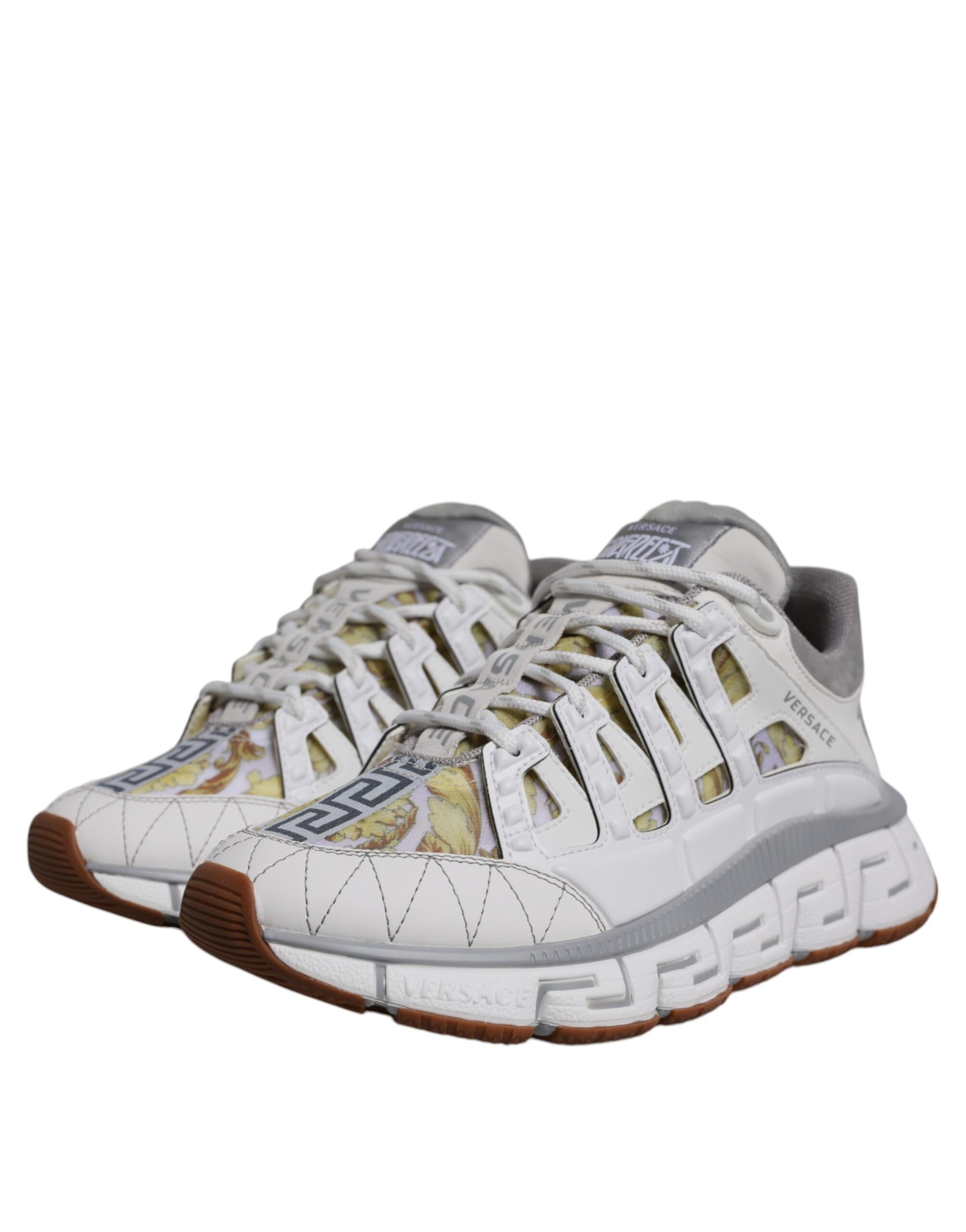 White sneakers with red accents and a patterned design on the side